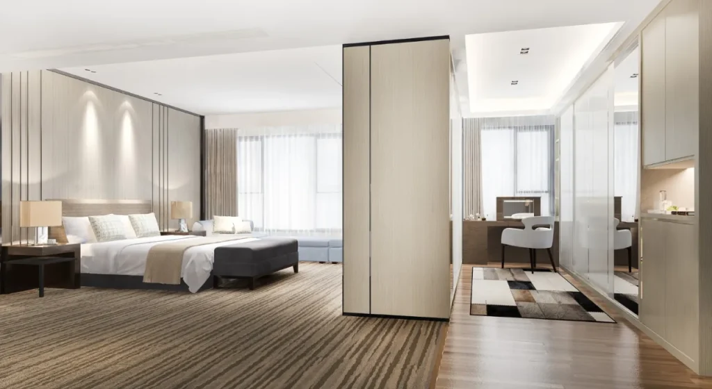 A stylish hotel room showcasing a bed, desk, and television, ideal for relaxation and work.