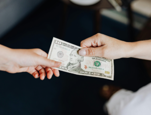 Client tipping professional cleaner from Lilly's Cleaning Service after Odessa, TX home cleaning