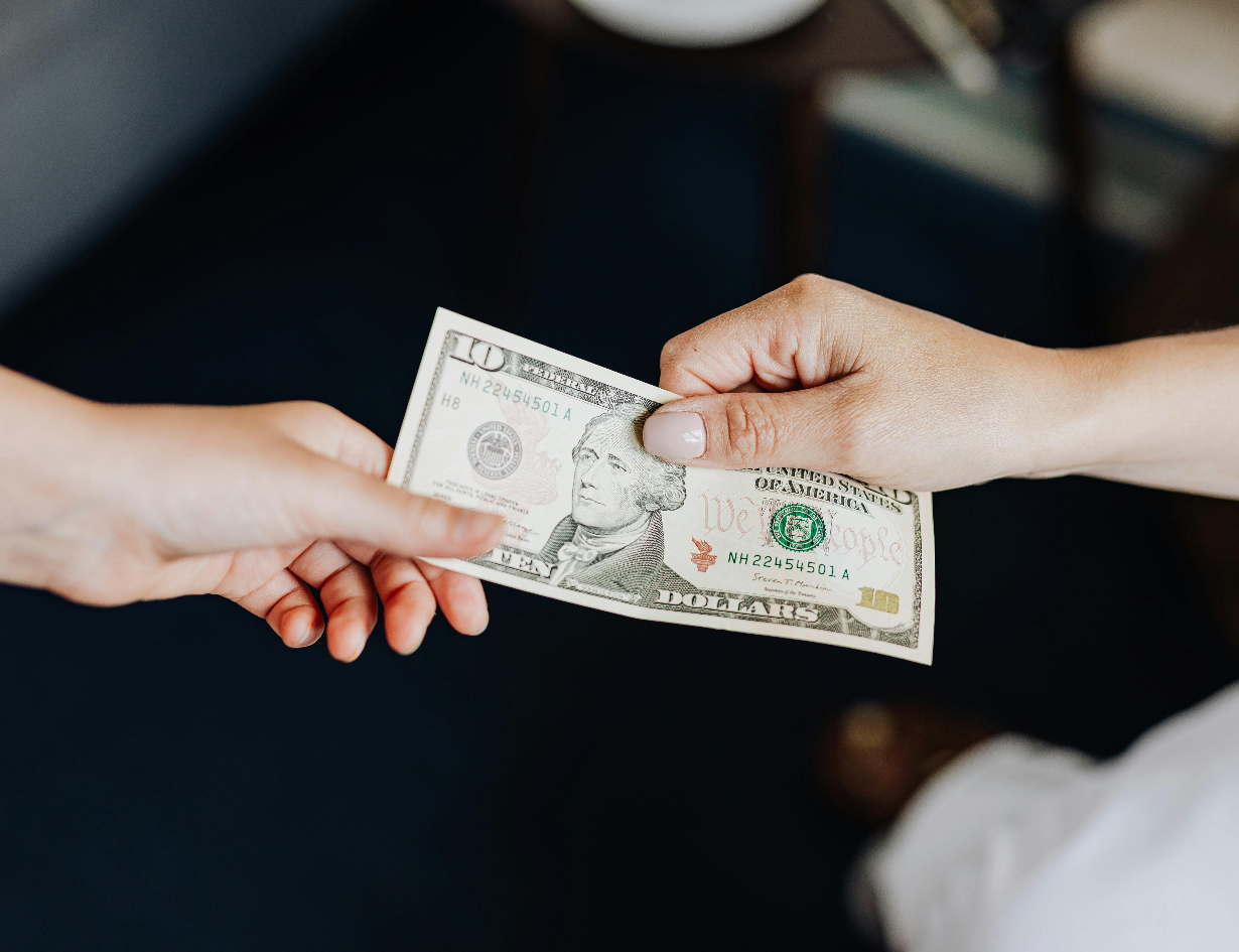 Client tipping professional cleaner from Lilly's Cleaning Service after Odessa, TX home cleaning