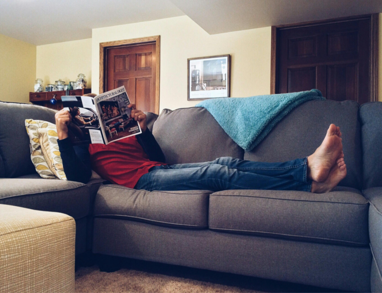Gray leather sectional sofa in a clean living room setting for leather stain removal tips